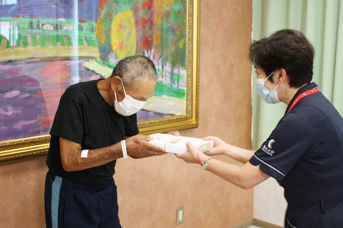 患者様へプレゼントを渡す看護部長